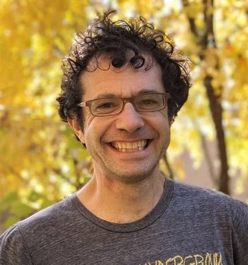 Ben Urwand, college essay coach and founder of Real College Essays, smiling outdoors in front of fall foliage