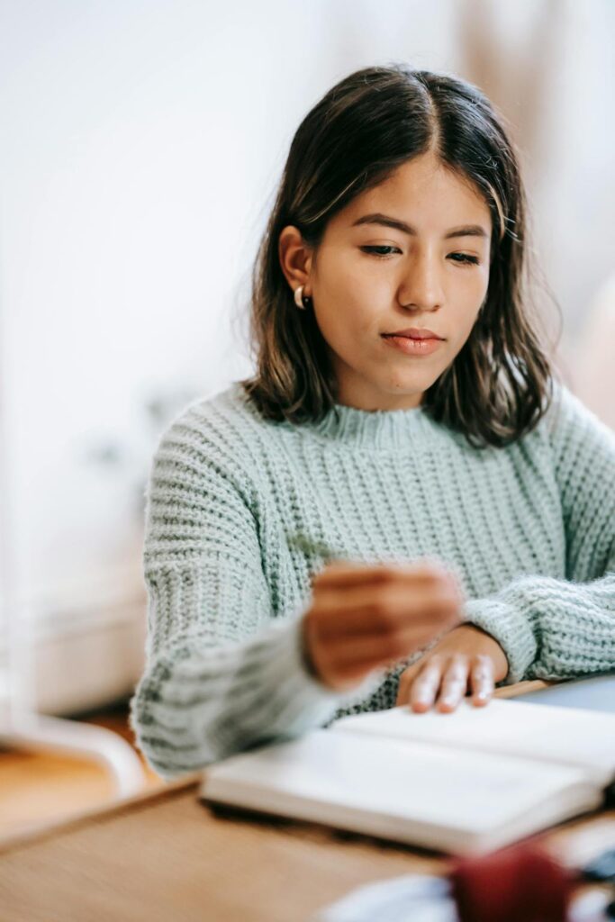 High school student working on a college essay during a coaching session