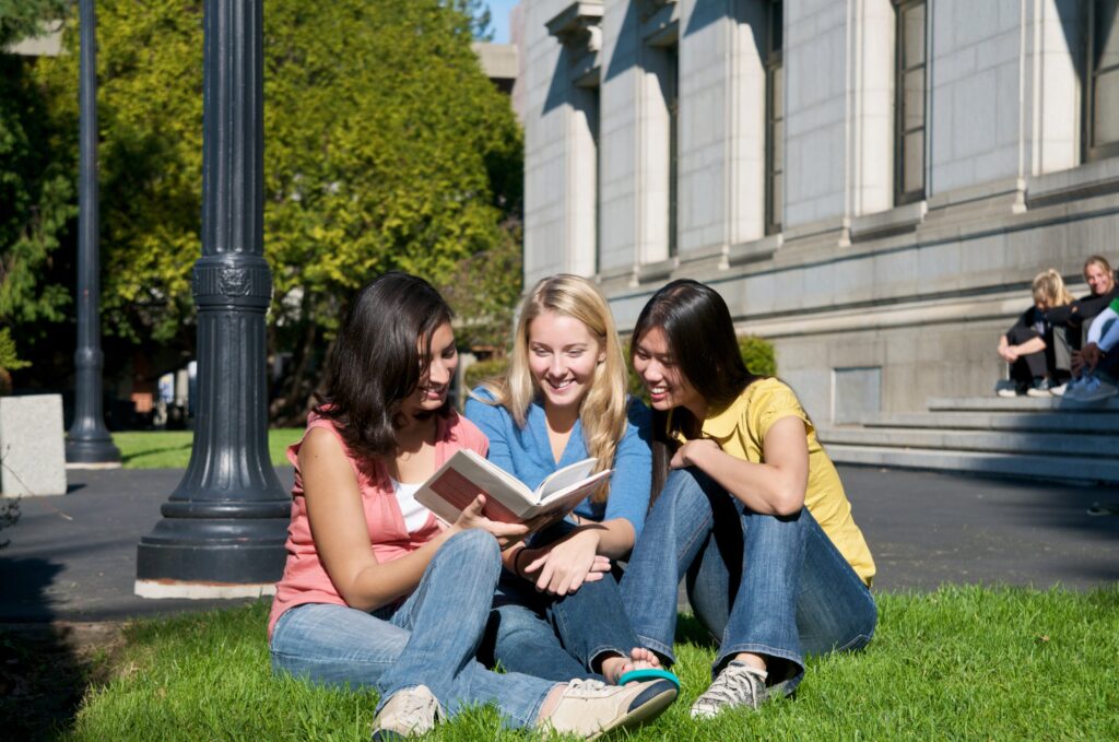 University of California students discussing personal insight questions on campus lawn